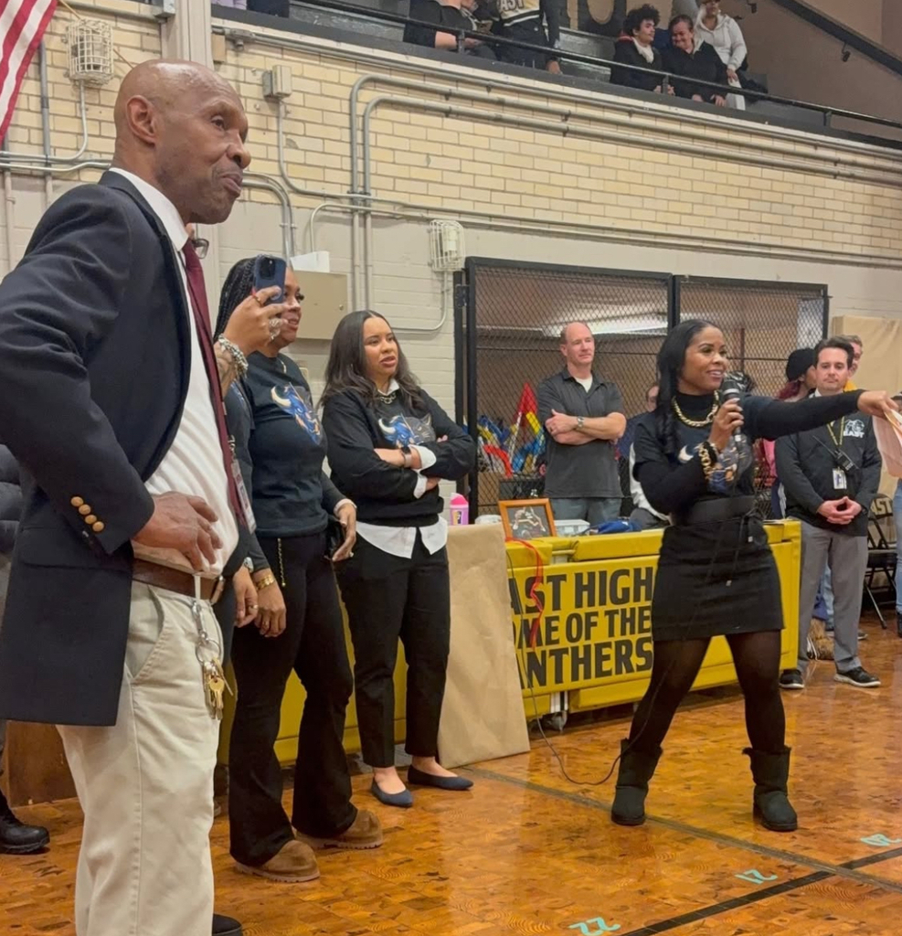 Coach Bryant and Marquita Bryant talking on a micorphone.
