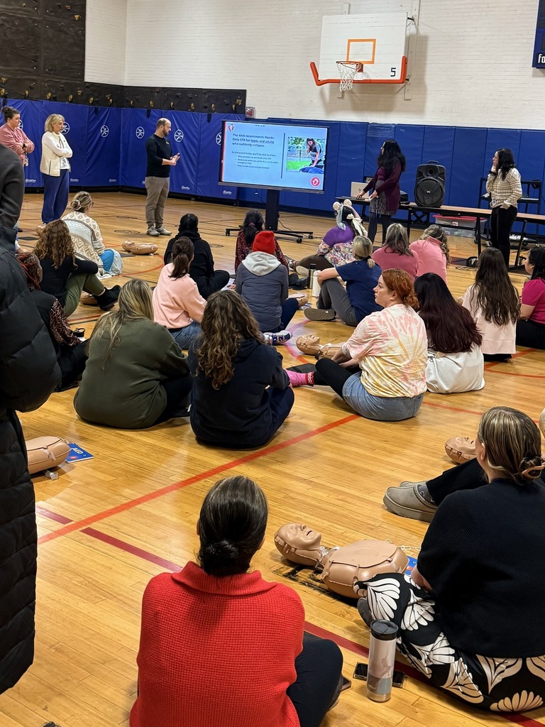 Teacher Learning CPR in a Gym