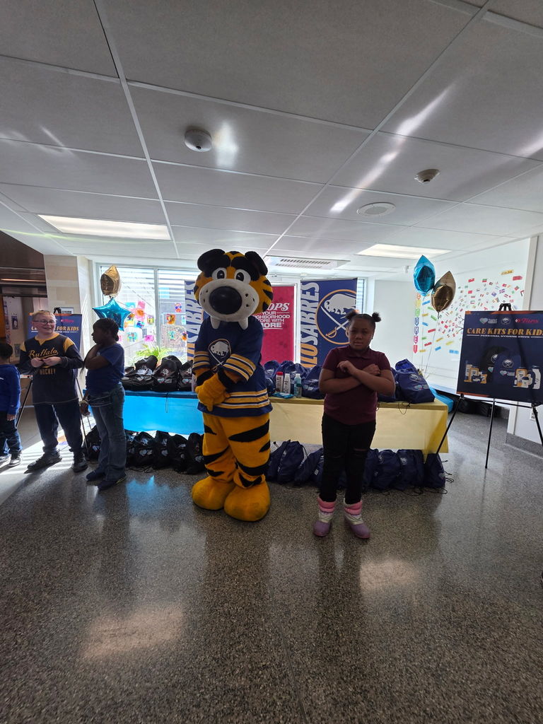 Student with Sabretooth Sabres Mascot