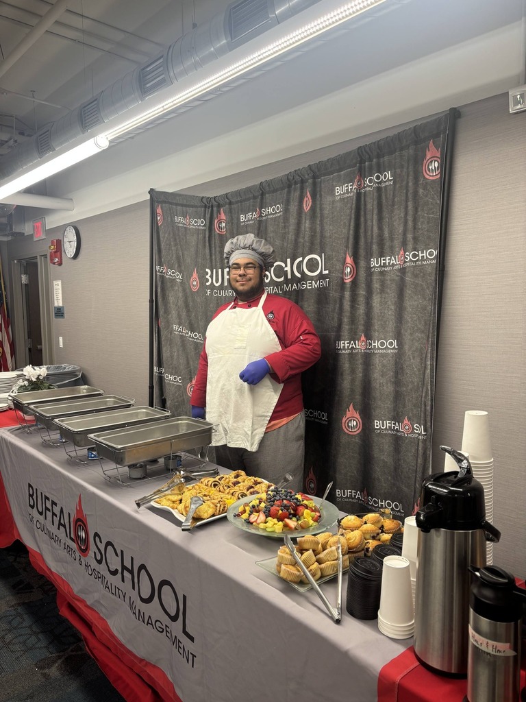 Student at food station servring food.