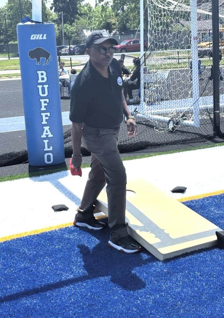 superintendent playing cornhole