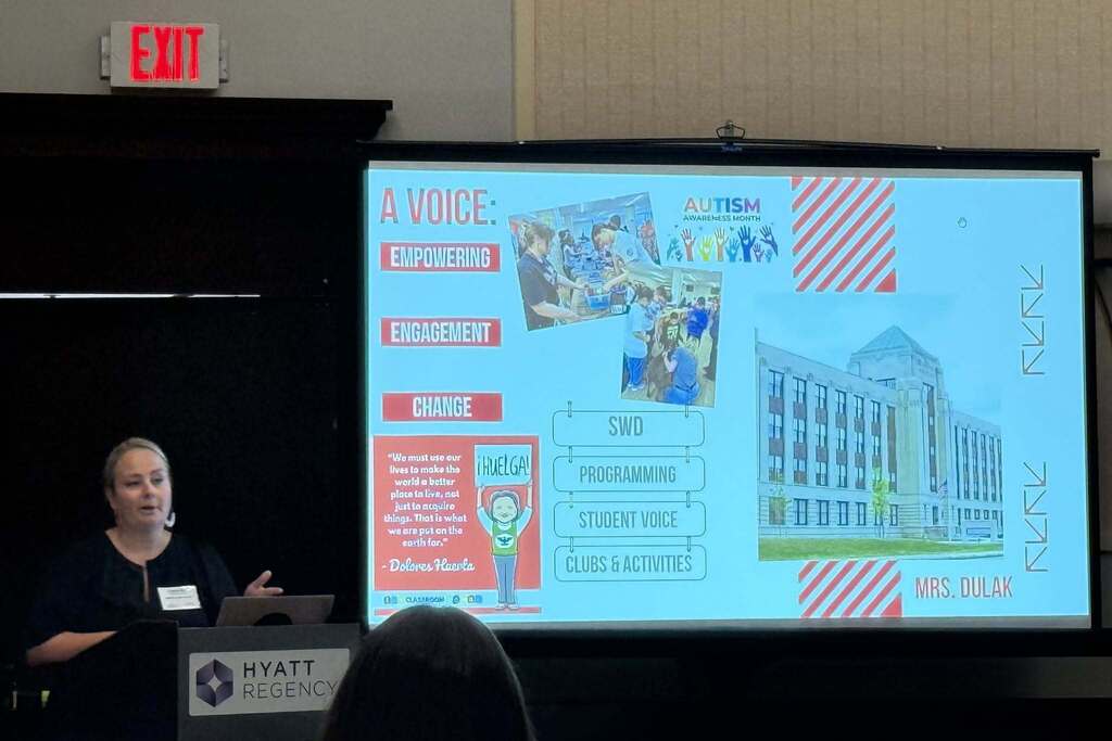 School Leader giving a presentation with screen in back