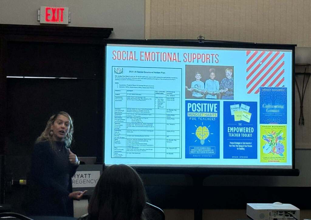 School Leader giving a presentation with screen in back