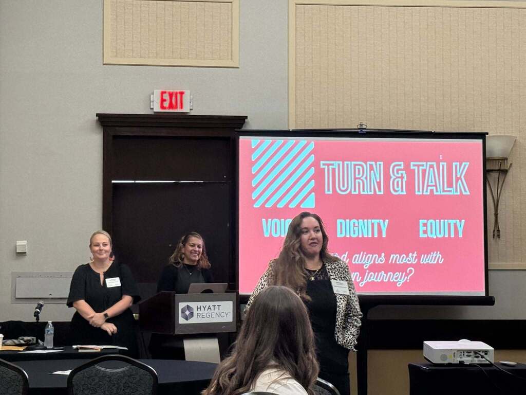 School Leader giving a presentation with screen in back