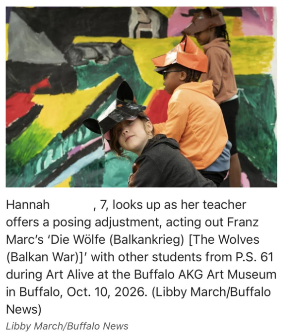 Hannah Nelson, 7, looks up as her teacher offers a posing adjustment, acting out Franz Marc's 'Die Wolfe (Balkankrieg) [The Wolves (Balkan War)]' with other students from P.S. 61 during Art Alive at the Buffalo AKG Art Museum in Buffalo, Oct. 10, 2026. (Libby March/Buffalo News)