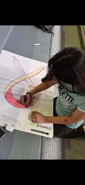 Child Drawing a pink ribbon