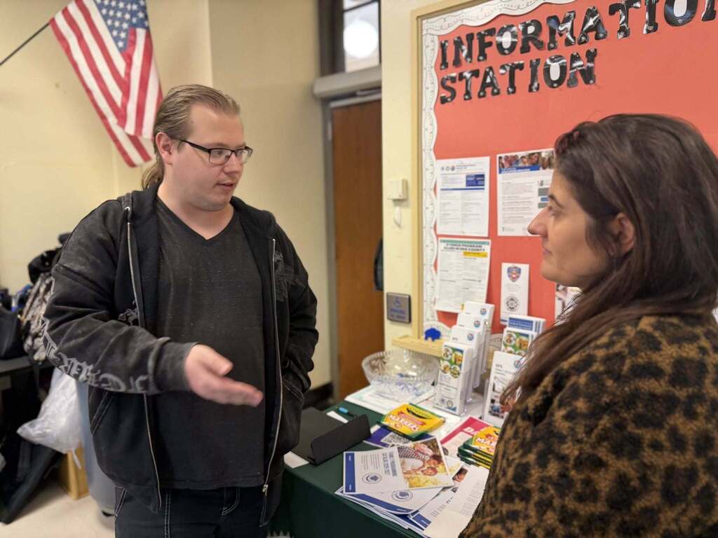 BPS parents conversing, and training in  a classroom