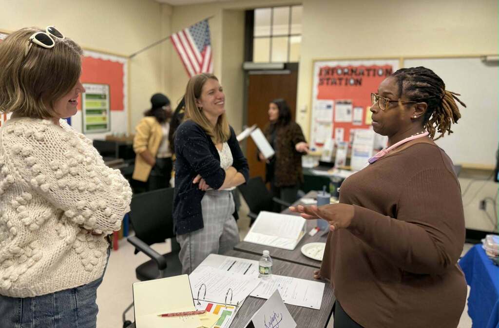 BPS parents conversing, and training in  a classroom