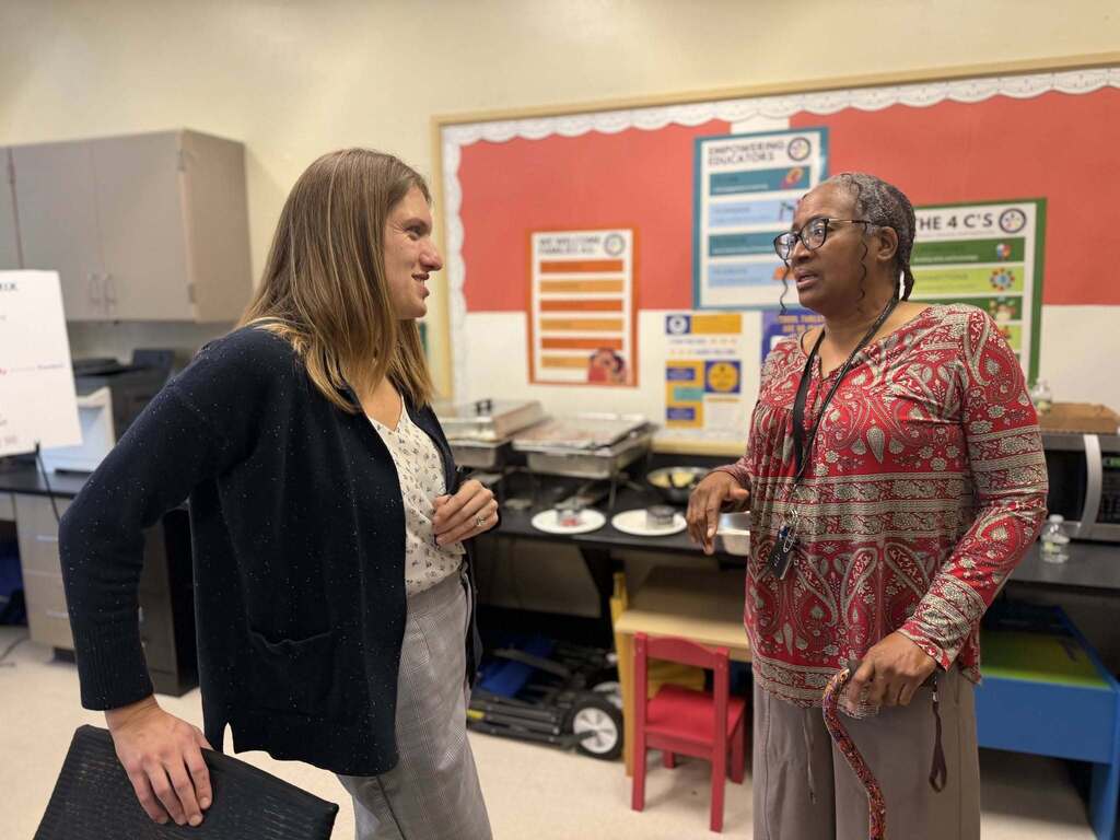 BPS parents conversing, and training in  a classroom