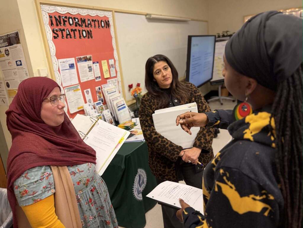BPS parents conversing, and training in  a classroom