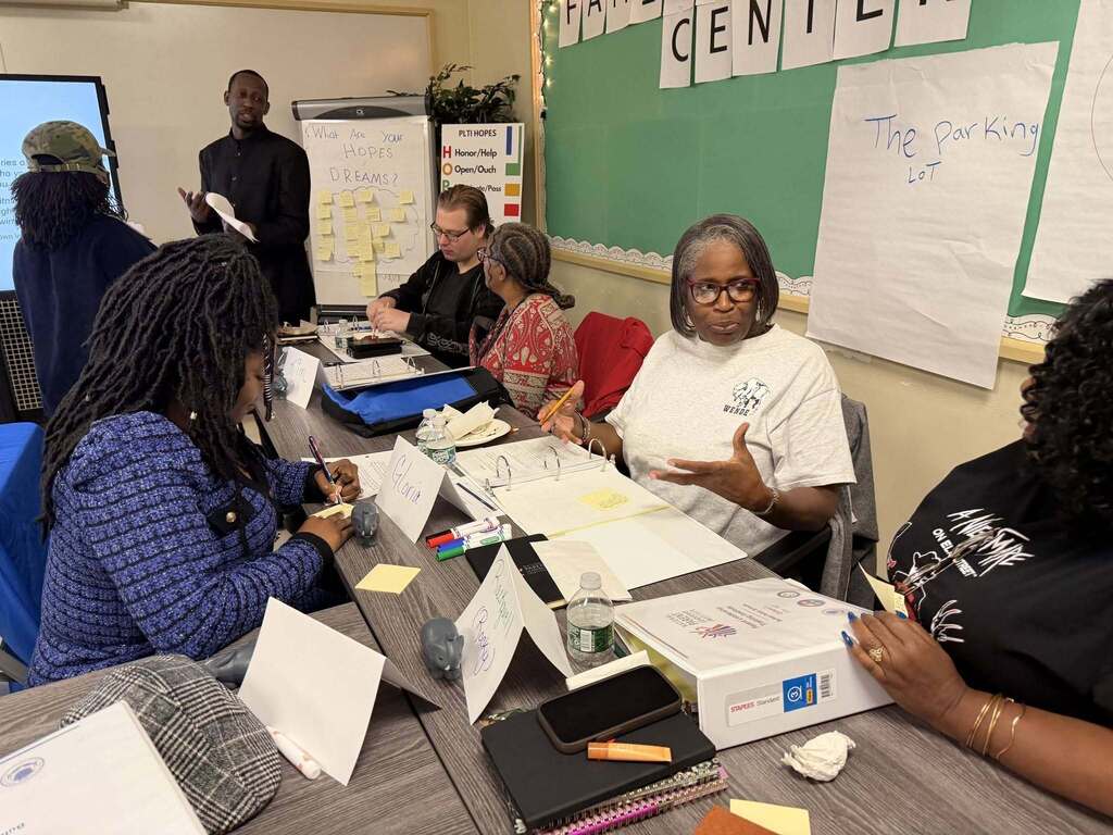 BPS parents conversing, and training in  a classroom
