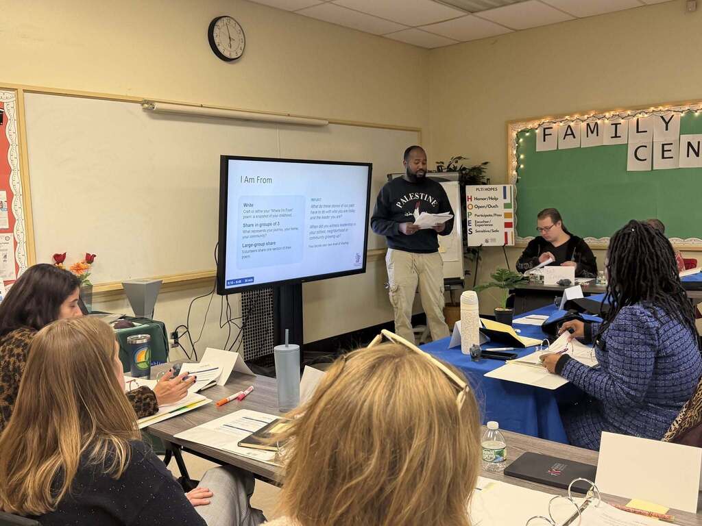 BPS parents conversing, and training in  a classroom