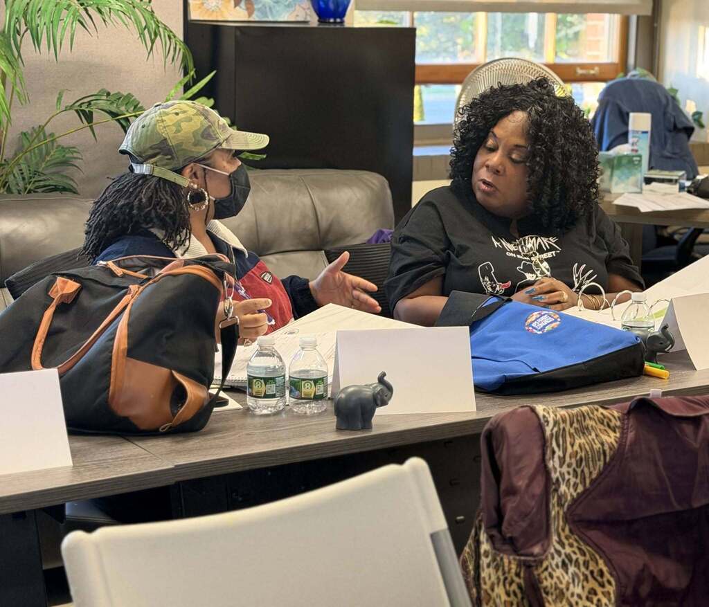 BPS parents conversing, and training in  a classroom