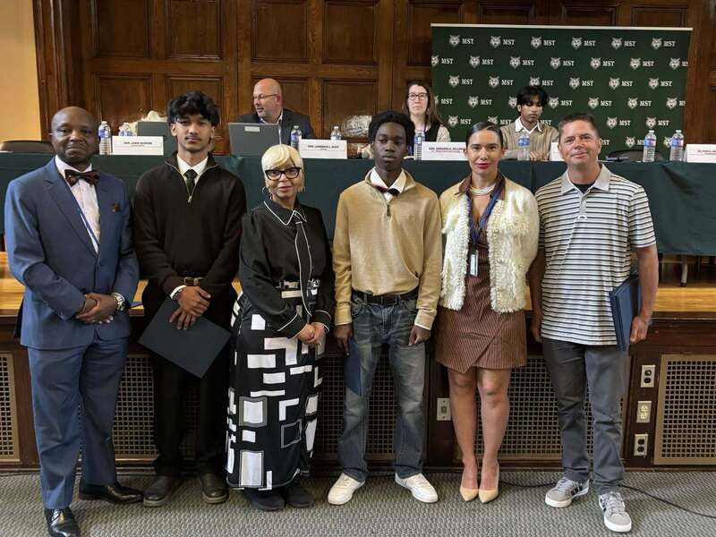 Superintendent Mubenga with Student Athletes, and Board Members