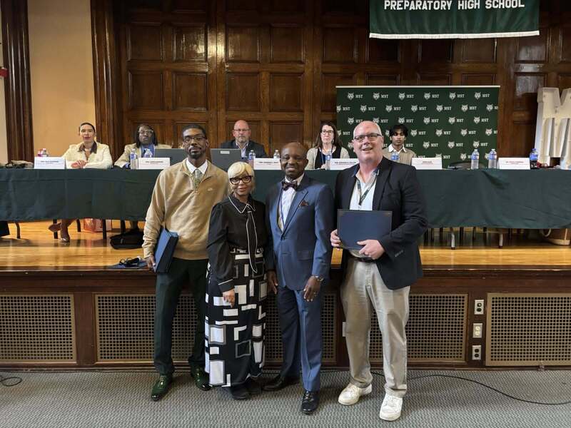 Superintendent Mubenga with Student Athletes, and Board Members