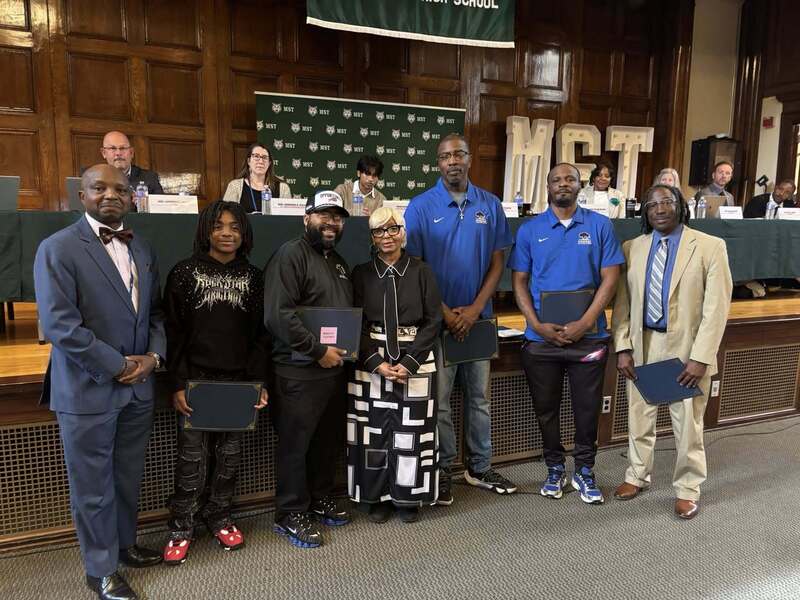 Superintendent Mubenga with Student Athletes, and Board Members