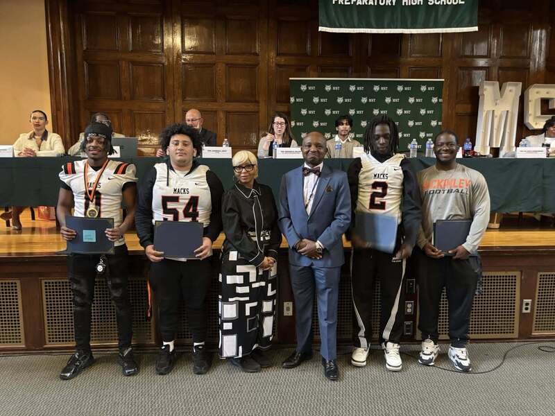 Superintendent Mubenga with Student Athletes, and Board Members