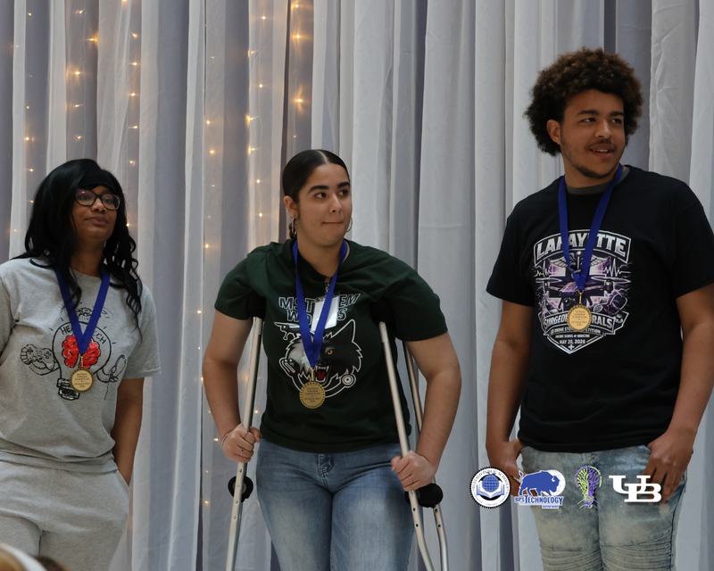 Studetns on stage with medals on their necks