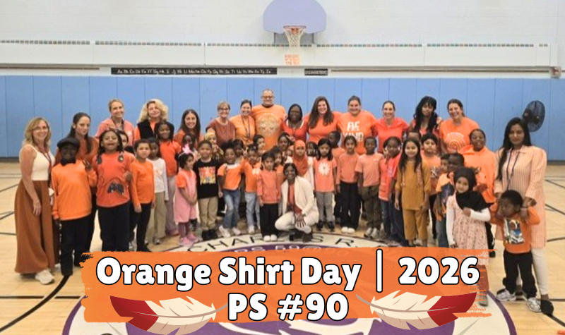 Lagre goup of Staff and Students in a group in Orange shirts