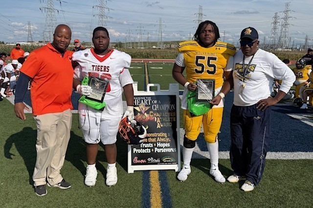Students and coaches posing with award