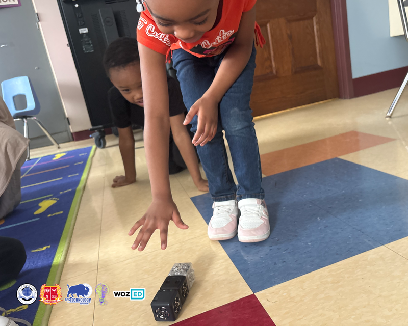 A kindergartener reaching for Cubelet Robots