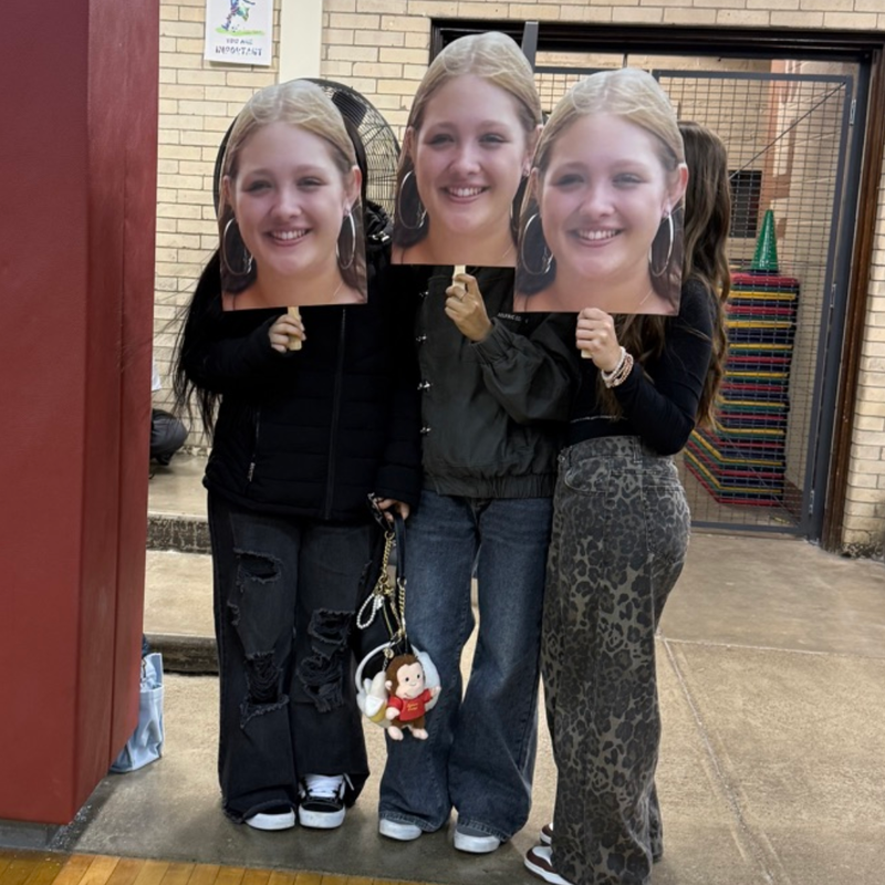 friends holding pictures of Madison