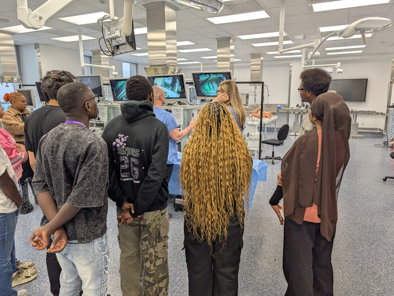 Students standing at screens playing drone simulator 