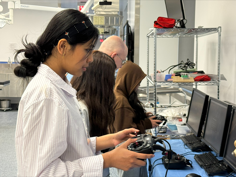 Girl playing Drone Simulator with controller in hand