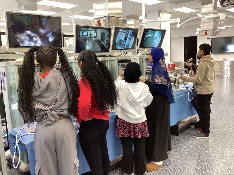 Students standing at screens playing drone simulator 