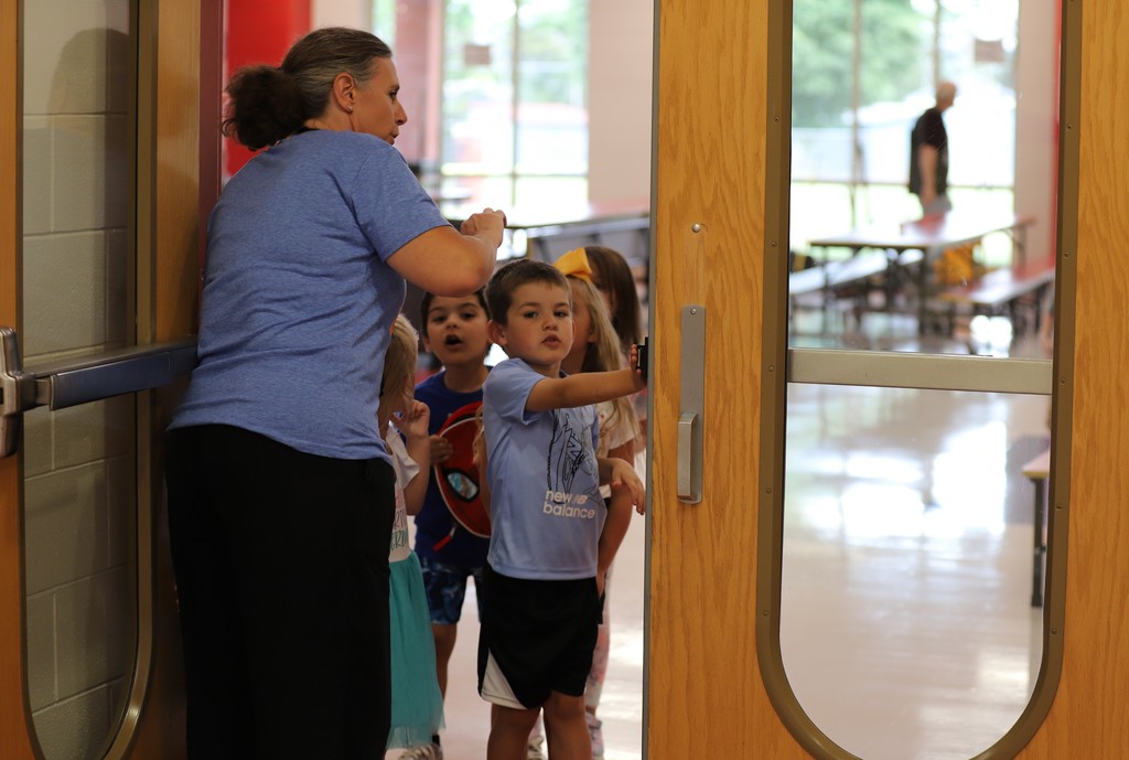 Teacher with students in lunchroom