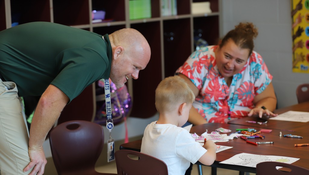 Dr. Bacon  and a teacher with a student coloring