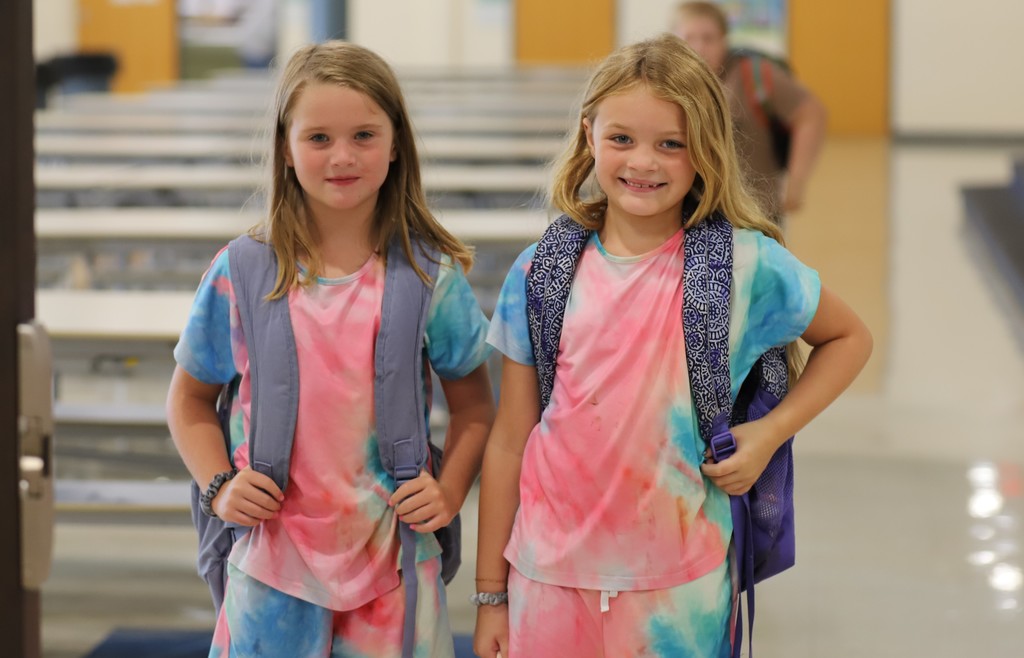 Two students in matching tie dye outfits