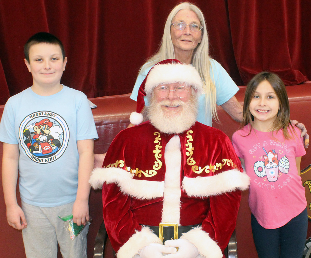 Students Ricky and Peyton, with their volunteer grandma and Santa!