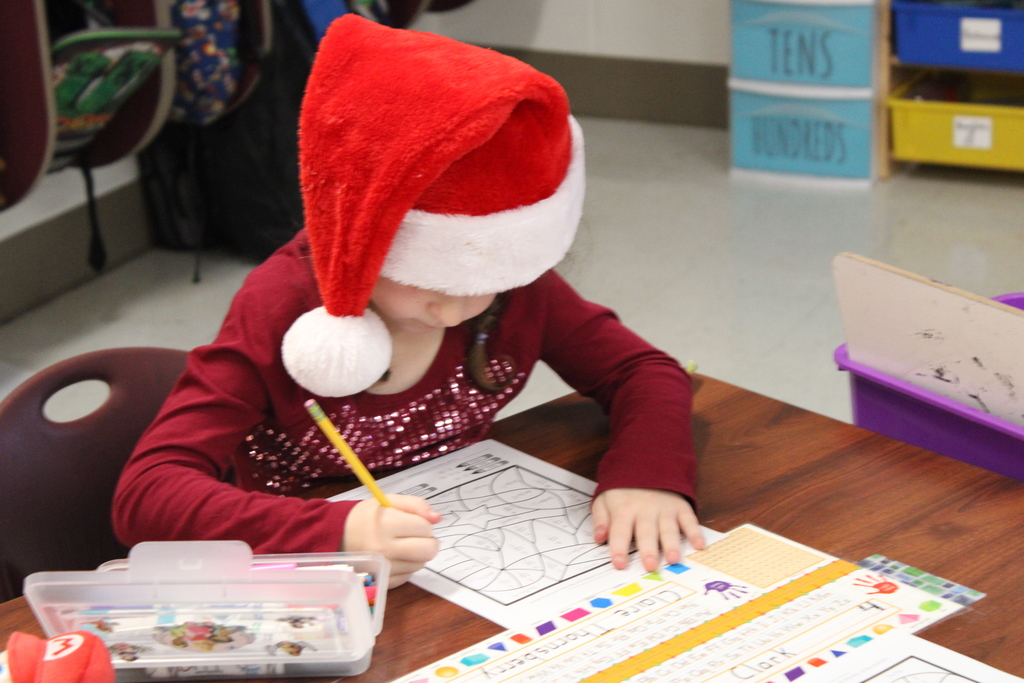 Claire, in second grade with a Santa hat