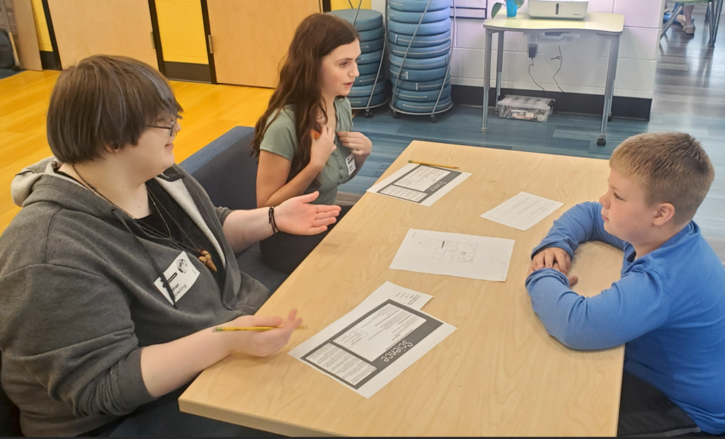 Two students providing feedback on design