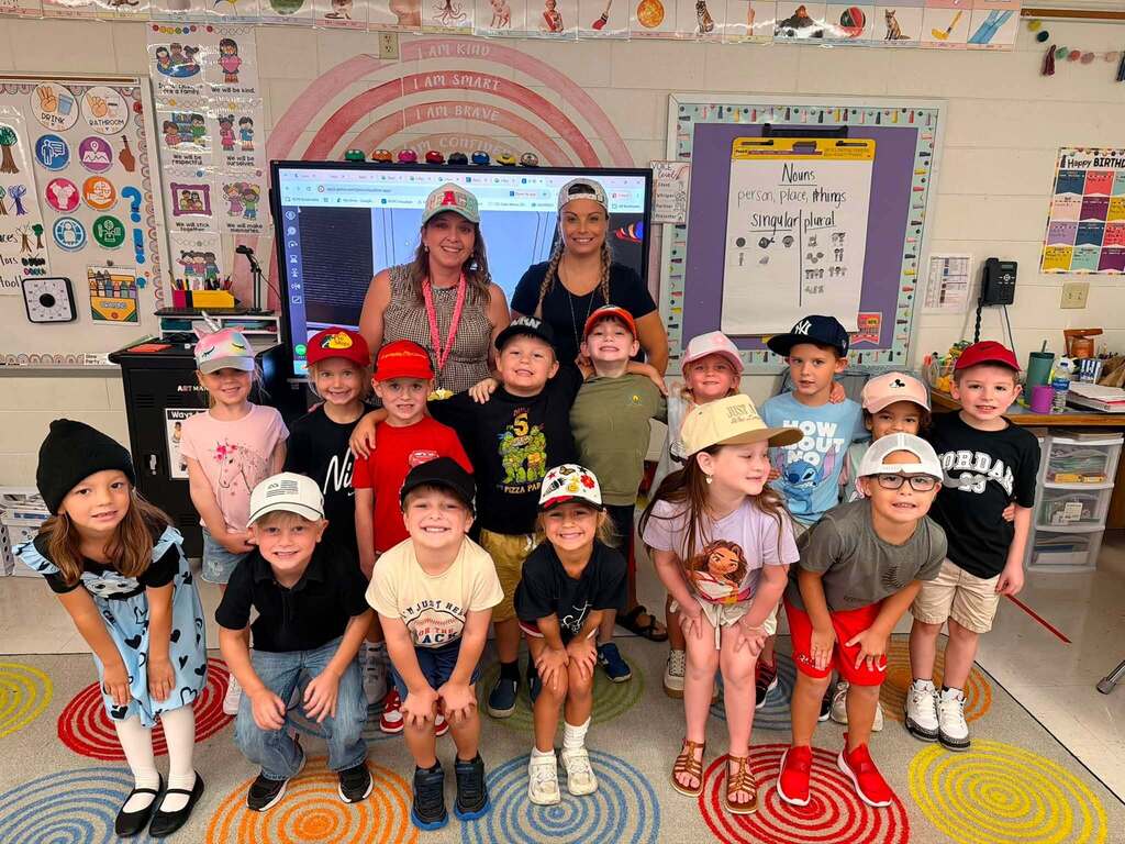 Childhood Cancer Awareness week: a classroom of students smiling with their teachers on hat day