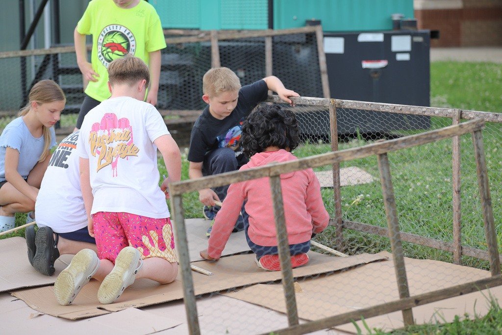 CES Pollinator Garden: building the pollinator garden with students measuring spots for plants