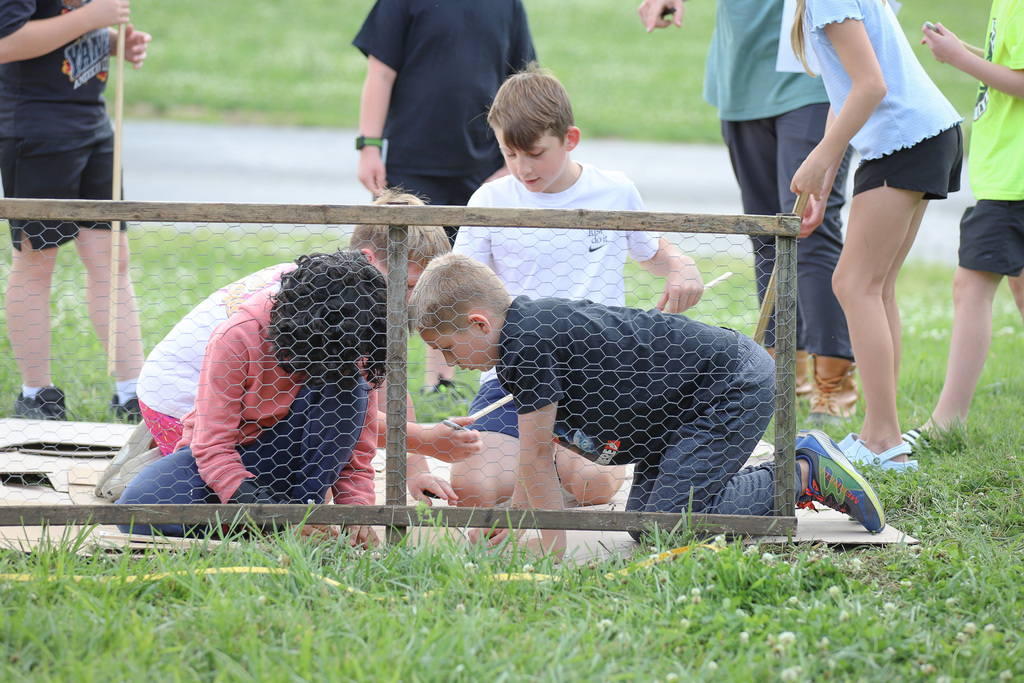 CES Pollinator Garden: building the pollinator garden with students measuring spots for plants