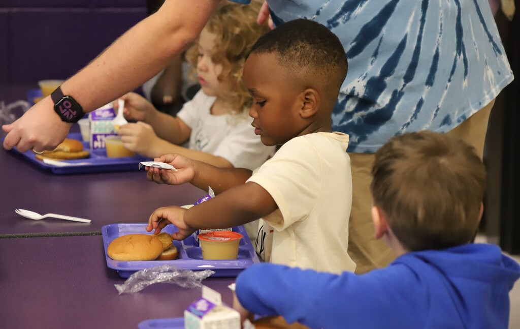National school lunch week; students smiling and eating lunch