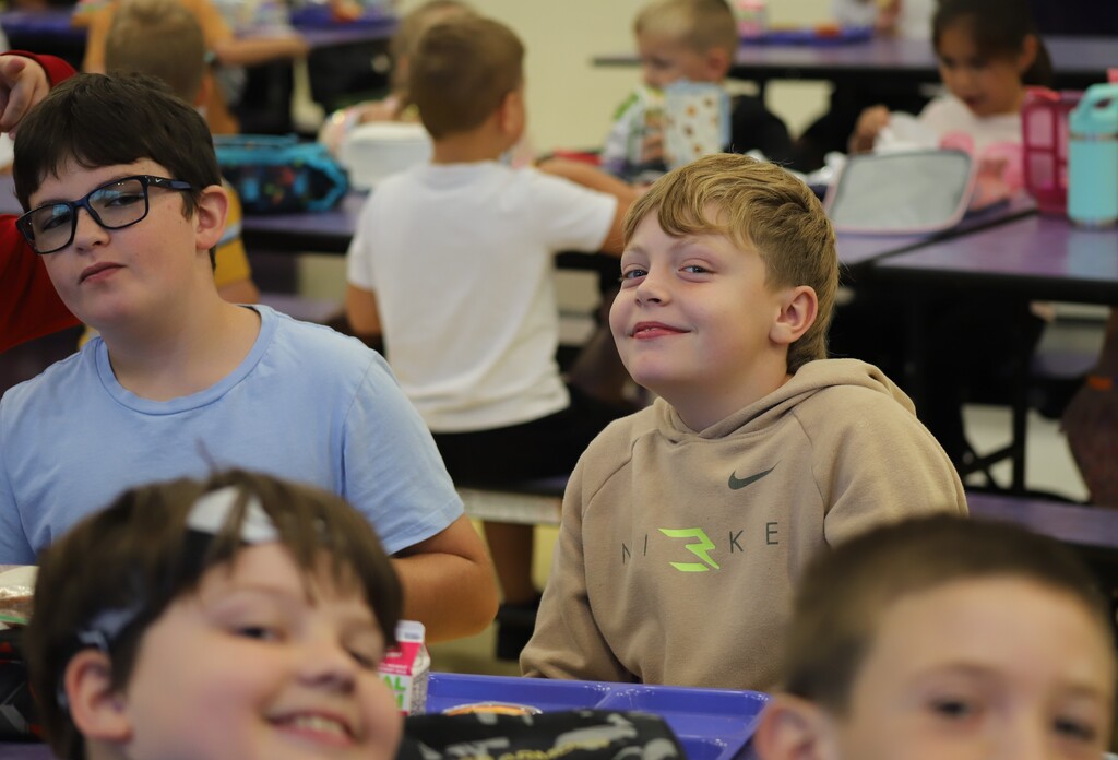 National school lunch week; students smiling and eating lunch