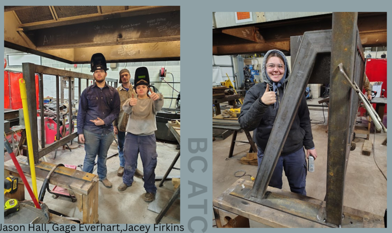 Students posing in front of work
