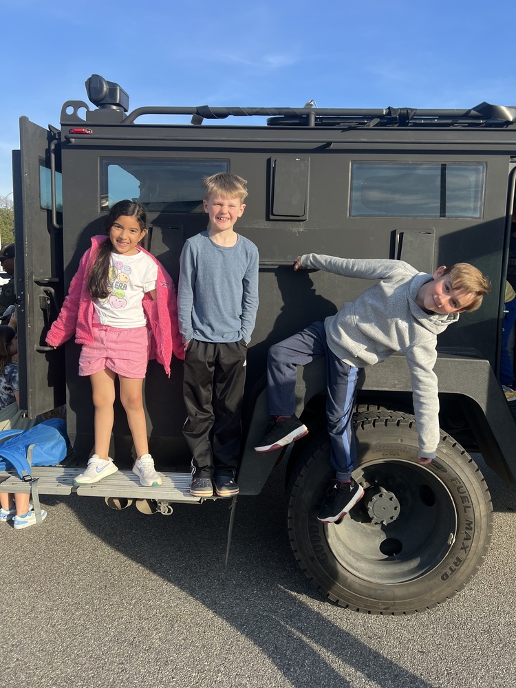 Students on the Bearcat car from the Buncombe County Sheriff's Department. 