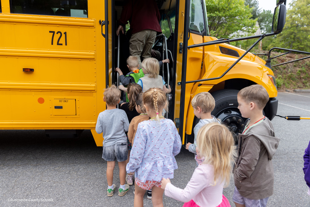 Preschool students getting on bus