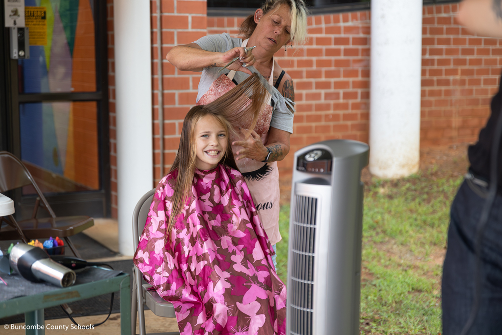 Female student receiving a free haircut. 