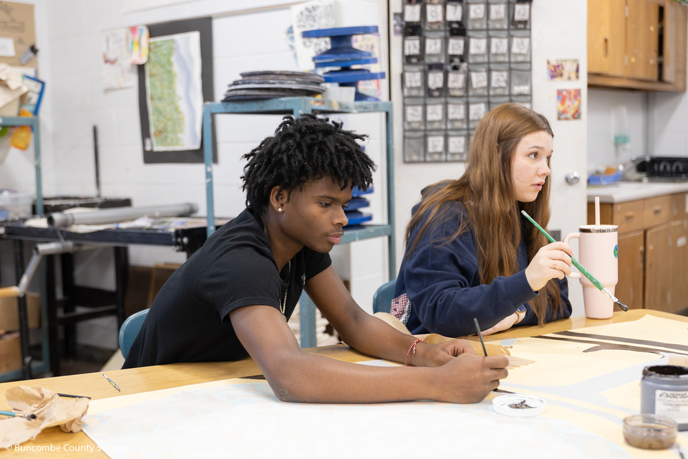 Student painting the art mural. 