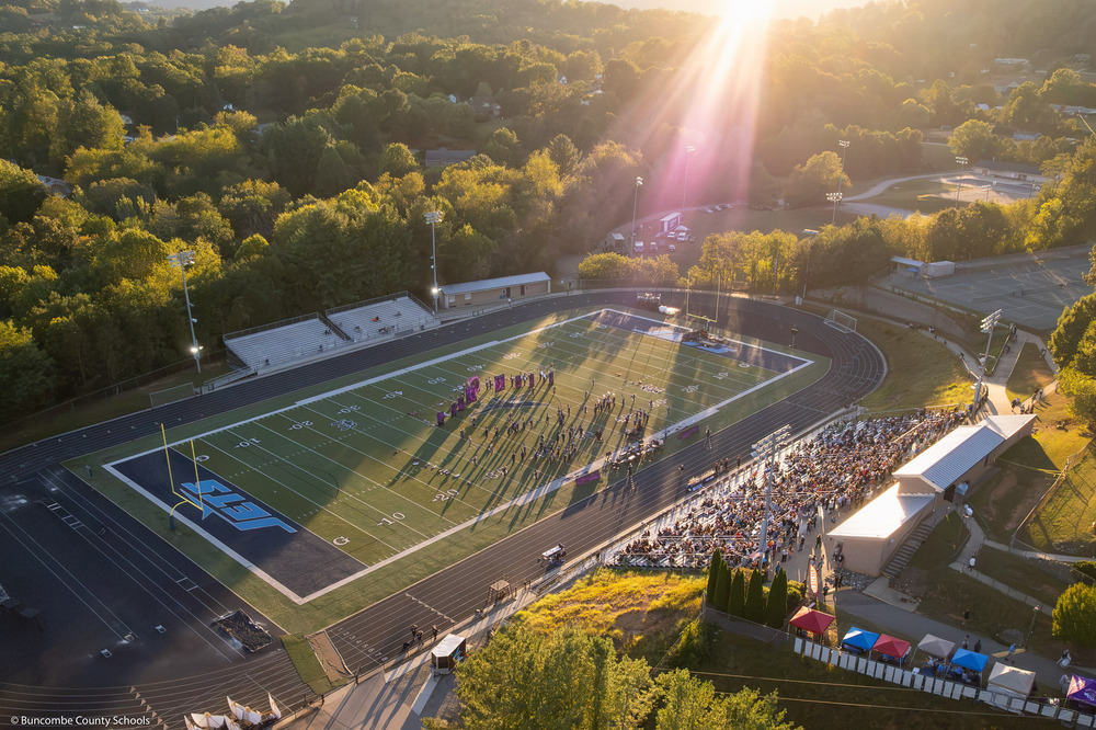 A drone image of a band performing on the football field.