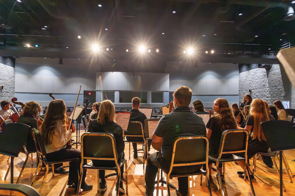 Musicians wait on stage before the middle school performance.