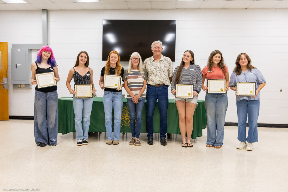The scholarship recipients pose with certificates with Bruce Johnson and Dr. Leigh Ann Hamon.