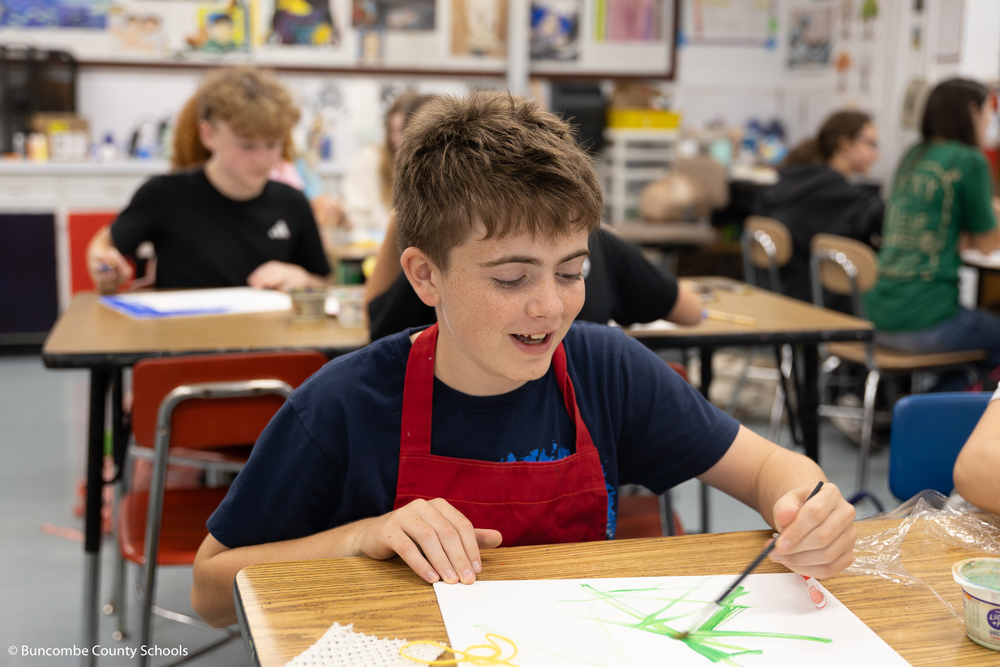 Boy painting a picture.