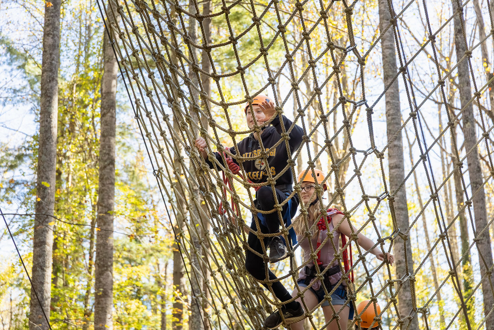 An Enka Middle student climbs on the ropes course.